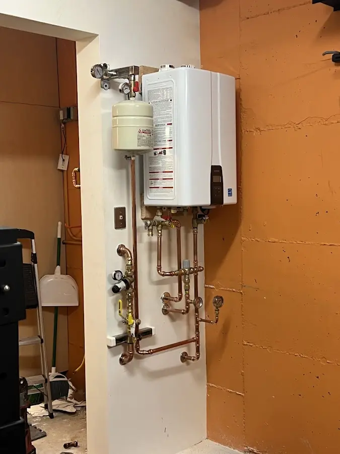 Plumbing technician inspecting water heater connections in Leisure World